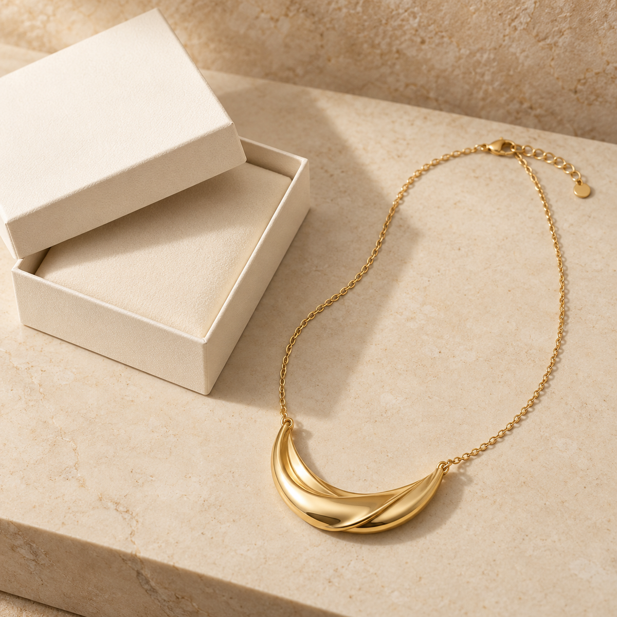 Gold-Tone Twisted Crescent Necklace with Sculptural Ribbon Pendant