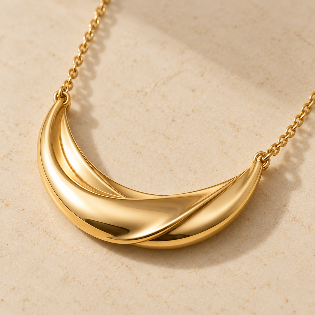 Gold-Tone Twisted Crescent Necklace with Sculptural Ribbon Pendant