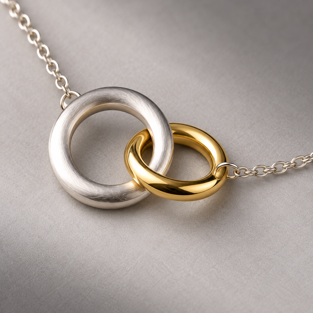 Two-Tone Orbit Necklace with Interlocked Unequal Rings